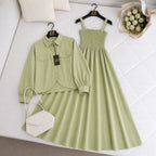 Green outfit with shirt, dress, and handbag on a white surface with 'ZM' branding.